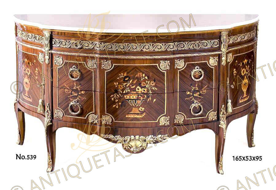 French earlier rococo, Louis XV style ormolu mounted commode after the model by Roger Vandercruse Lacroix under the direction of Gilles Joubert, Paris, 1769, inlaid with pictorial marquetry, eared marble topped, oval shape, classical motifs, large apron, fine ormolu mounts, three drawers and two doors, raised on ormolu mounted cabriole legs
